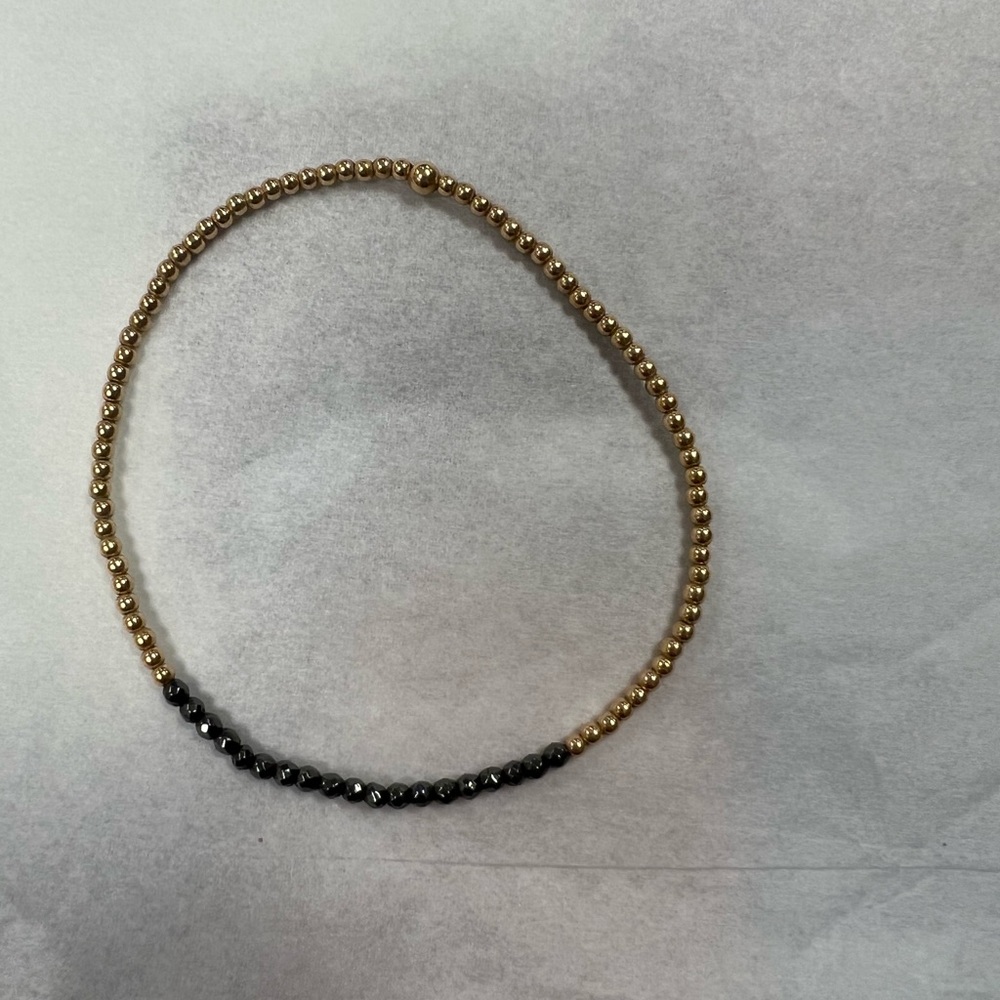 E newton black and gold bracelet